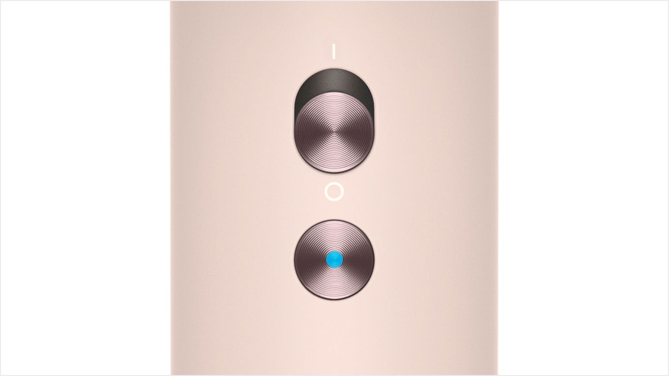Close-up of the Dyson Supersonic hair dryer's cold shot button.